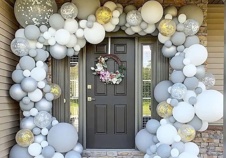 Elegant white and grey full balloon arch at a venue entrance for a UK bridal shower.