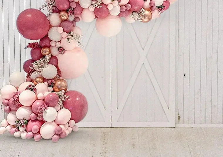 Bespoke pink and blush half-arch balloon decoration for a bridal shower entrance.