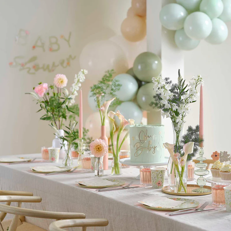 Premium botanical baby shower table styling in Bristol with sage green accents and white floral decor.