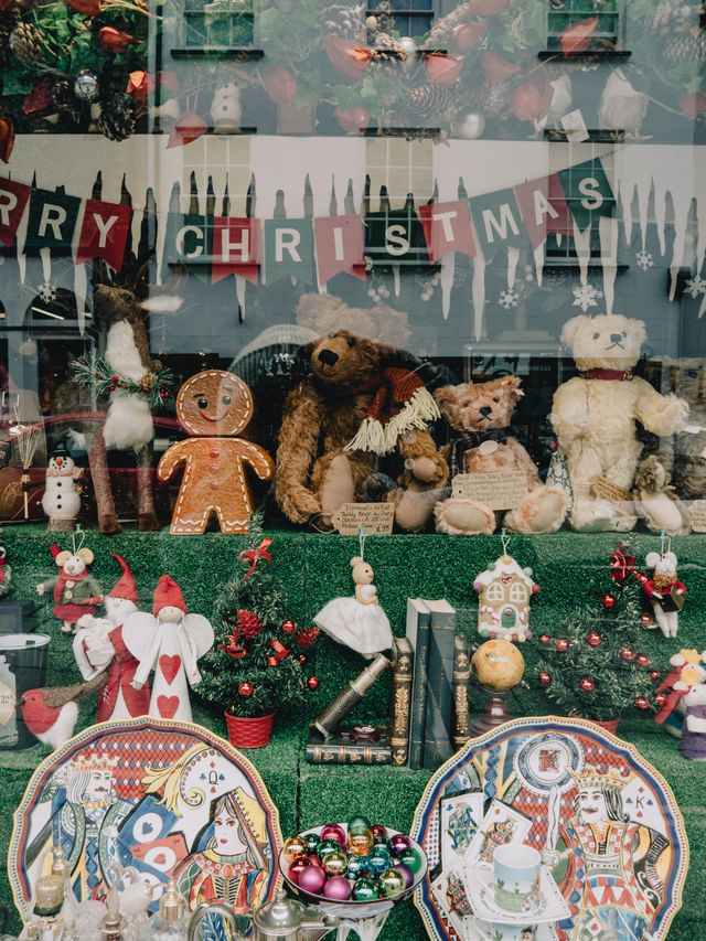 Commercial Christmas window display with warm lighting and garland for a UK retail business
