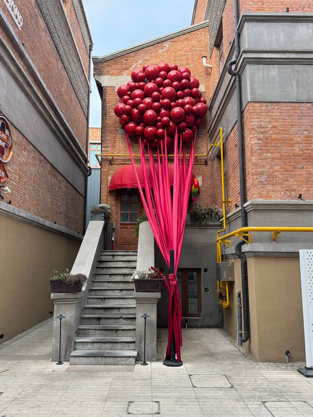 Organic balloon garland styled along a wall for a Bristol event
