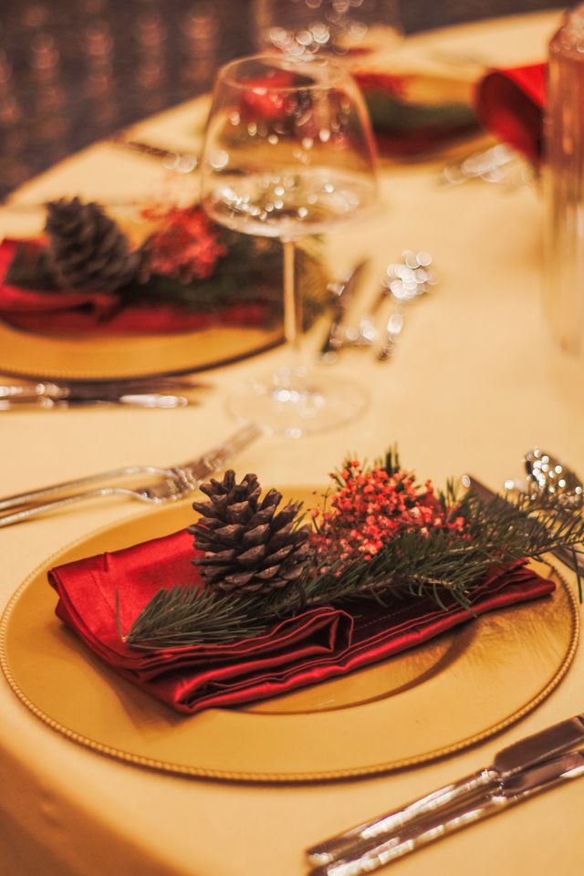 Styled Christmas table decorations with candles, centrepiece and place settings