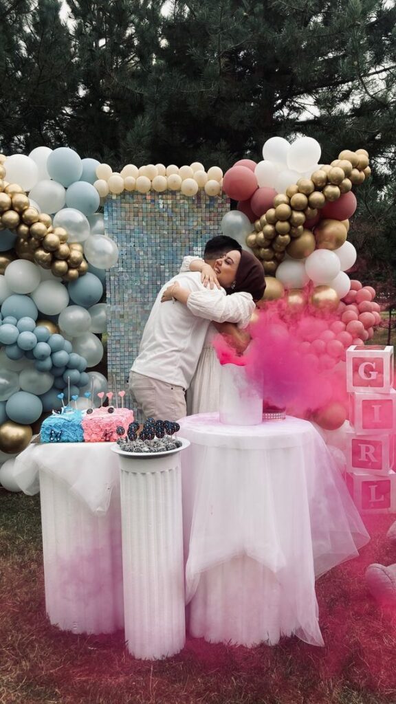 Couple reacting to gender reveal balloon moment at styled Bristol event