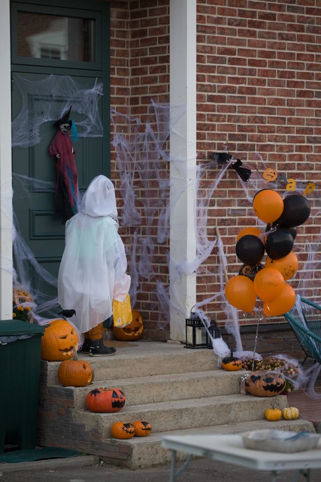 Weatherproof outdoor Halloween decorations on a Bristol terraced house porch at dusk