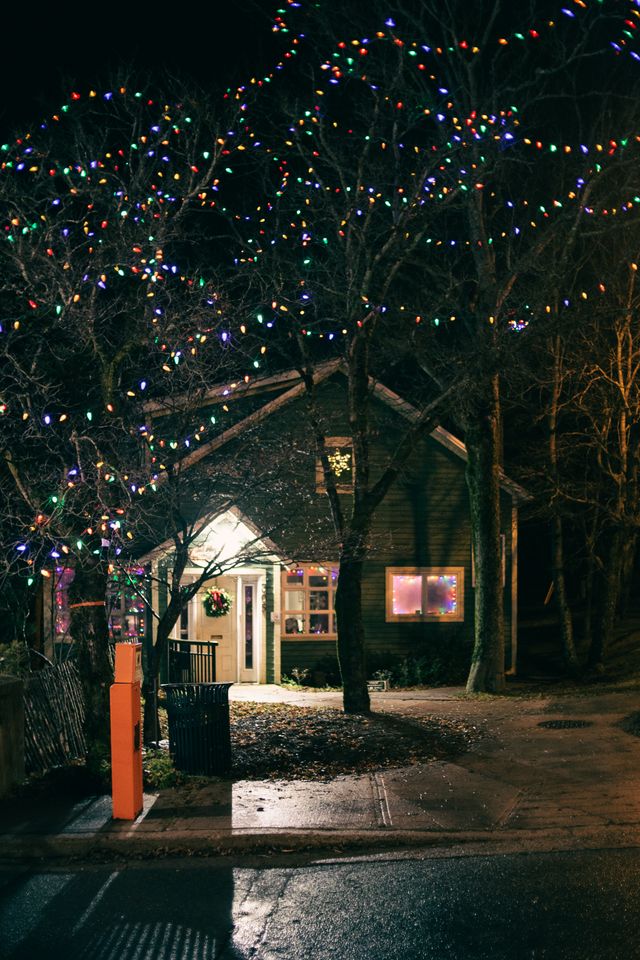 Professional Christmas light installation on a Bristol home roofline at dusk