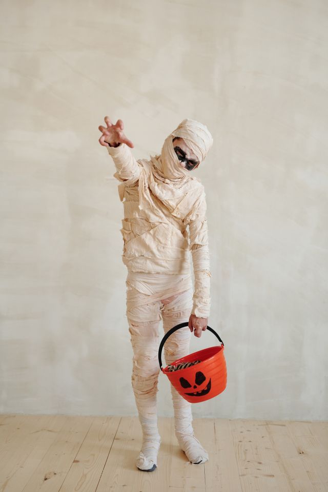 Children playing mummy wrap Halloween party game at a Bristol kids party